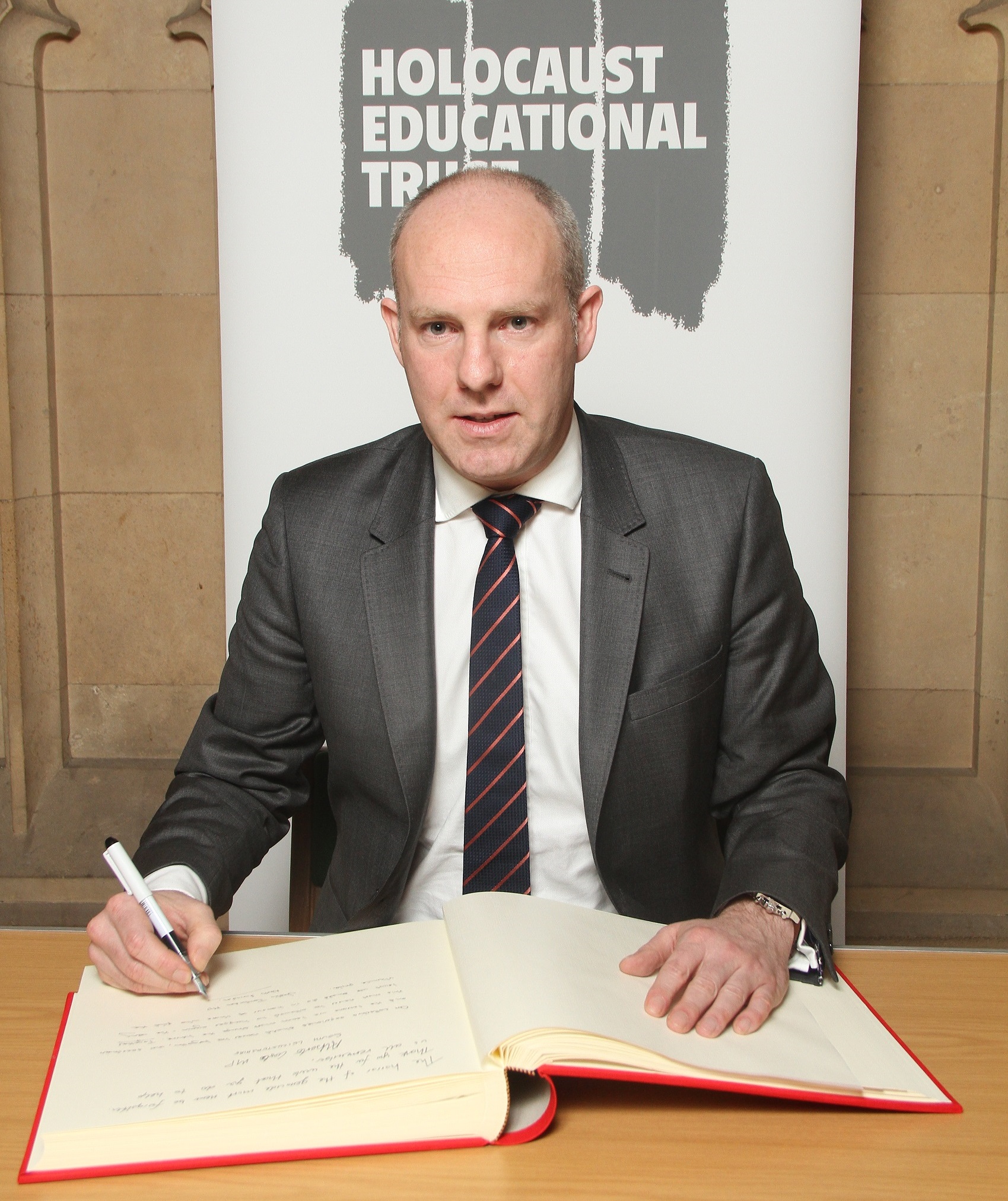 Justin Tomlinson MP Signs Holocaust Educational Trust Book Of Commitment